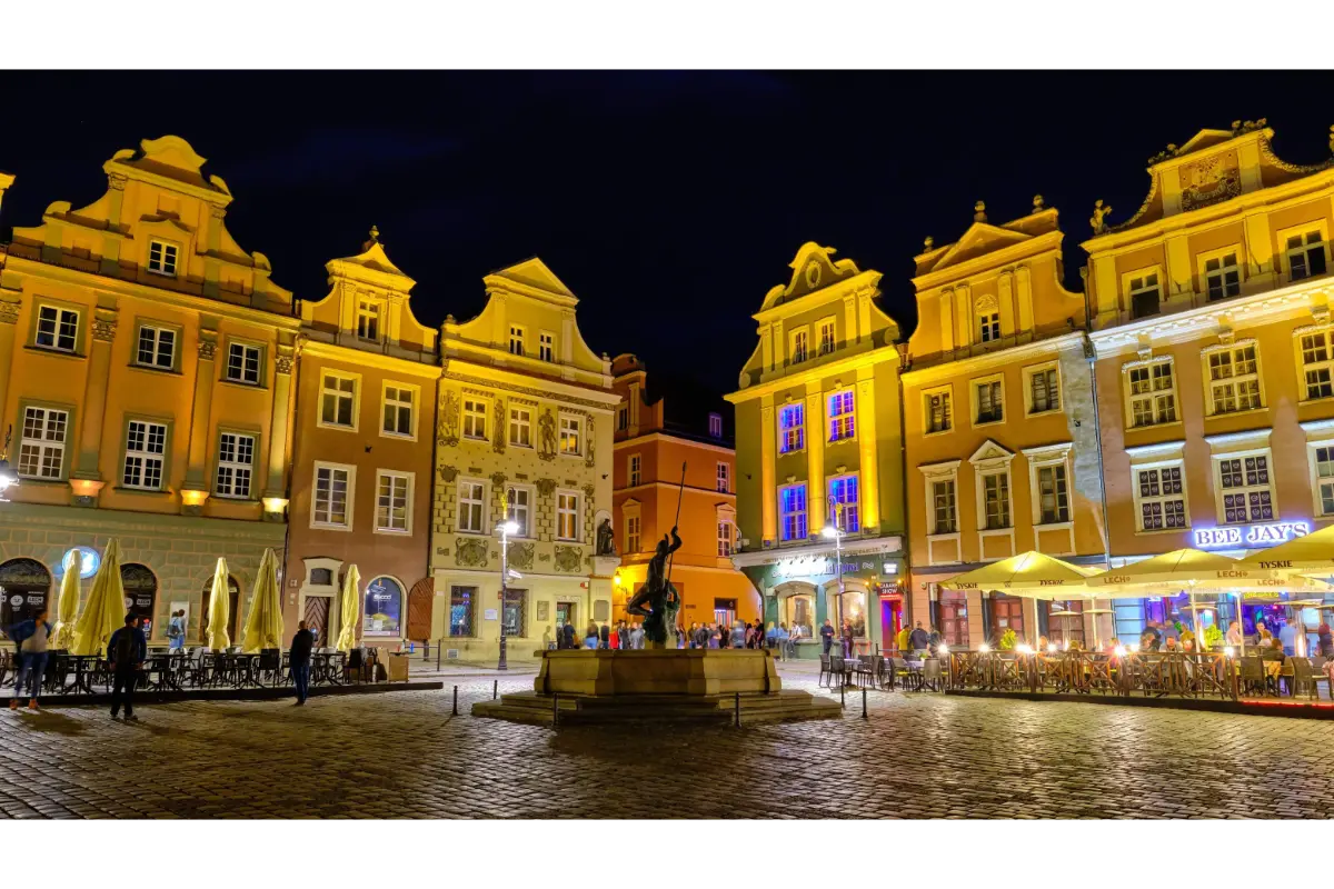 Historic buildings illuminated at night in Poznan Old Market Square, Poland