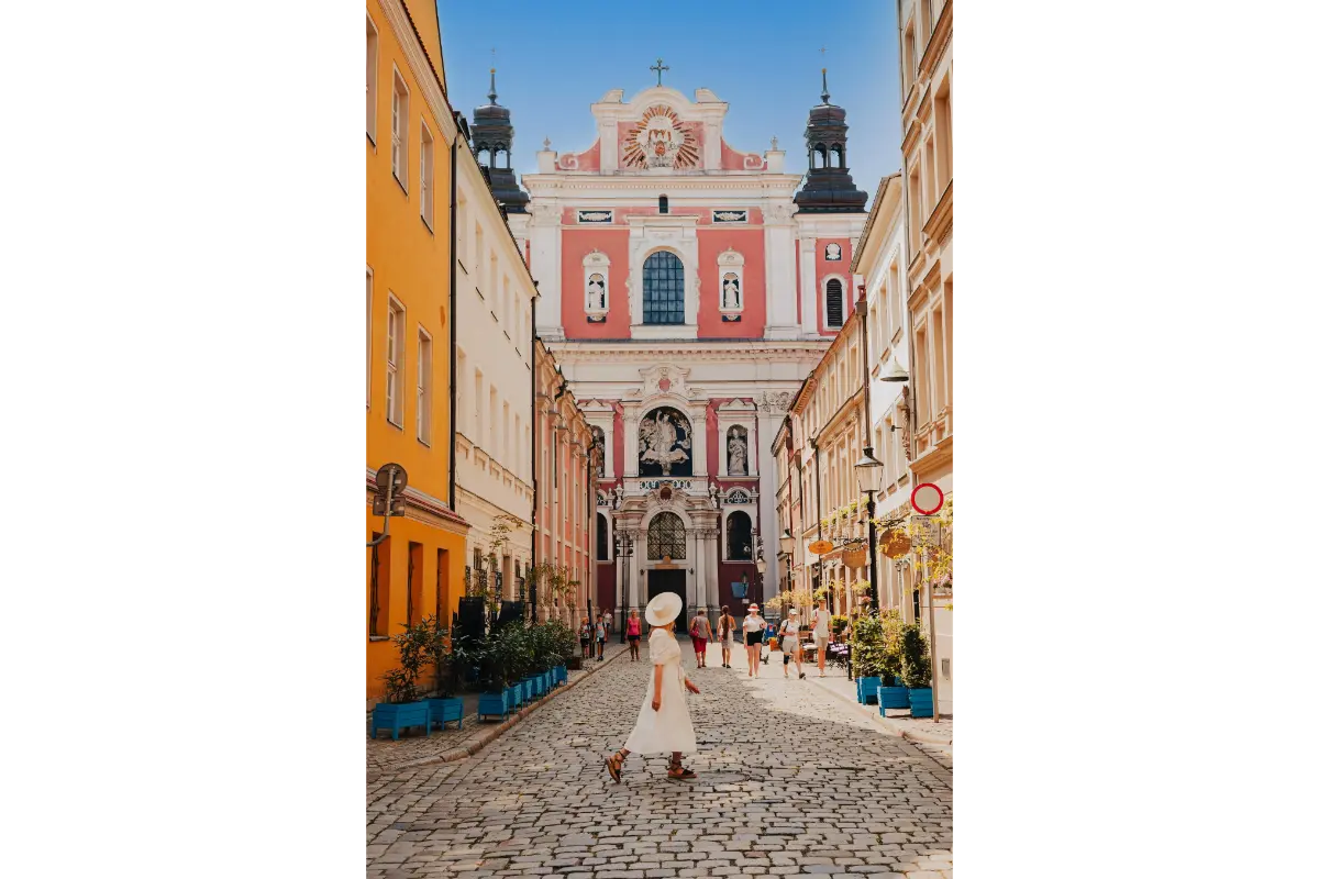 Visitor walking through a historic street in Poznan Old Town, Poland